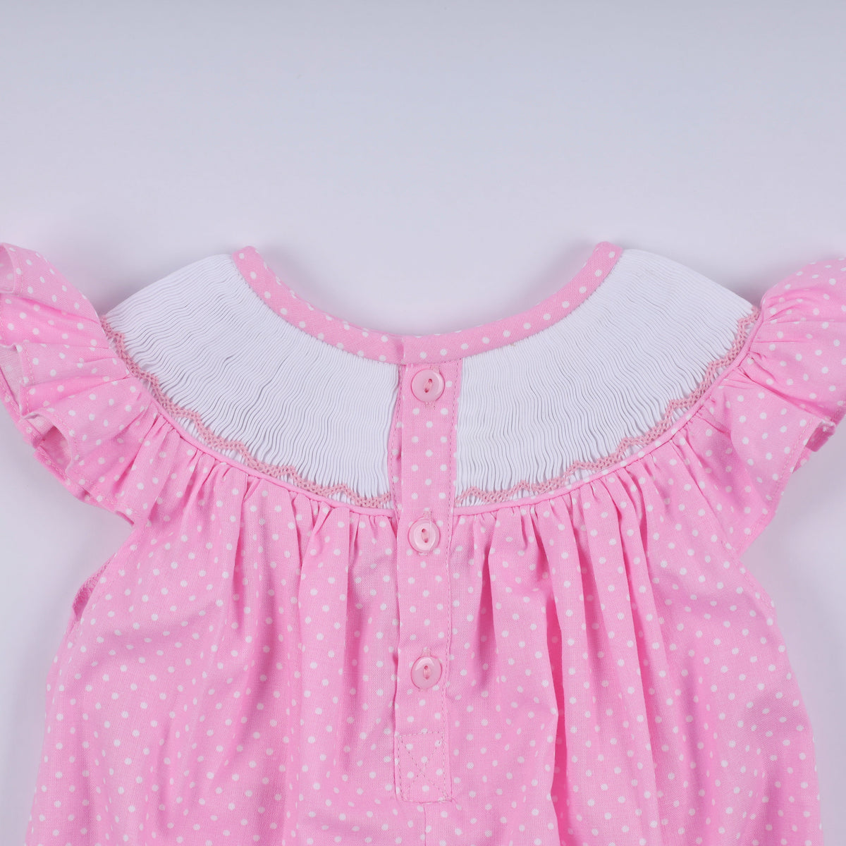 Pink character hand smocked dot ruffle bubble